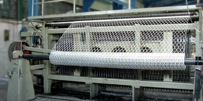 A machine is producing woven gabion rolls.