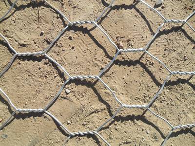 A piece of Galfan gabion with triple twisted structure on the ground.