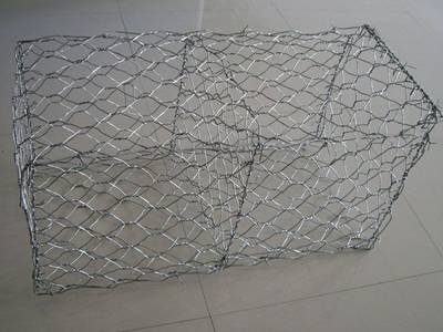 A woven Galfan gabion box on the ground.