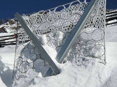 Hexagonal wire mesh is used with steel ring net and lots of snows on the net.