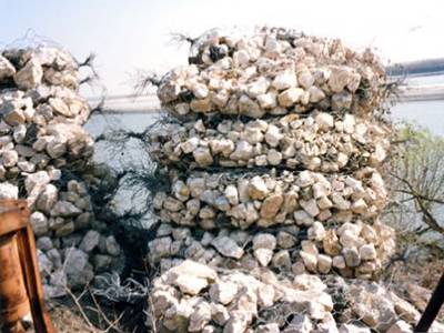 Several sack gabions are piled up beside of the river.
