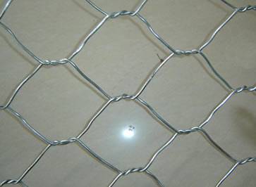 A sheet of galvanized steel wire gabion mesh on the floor.