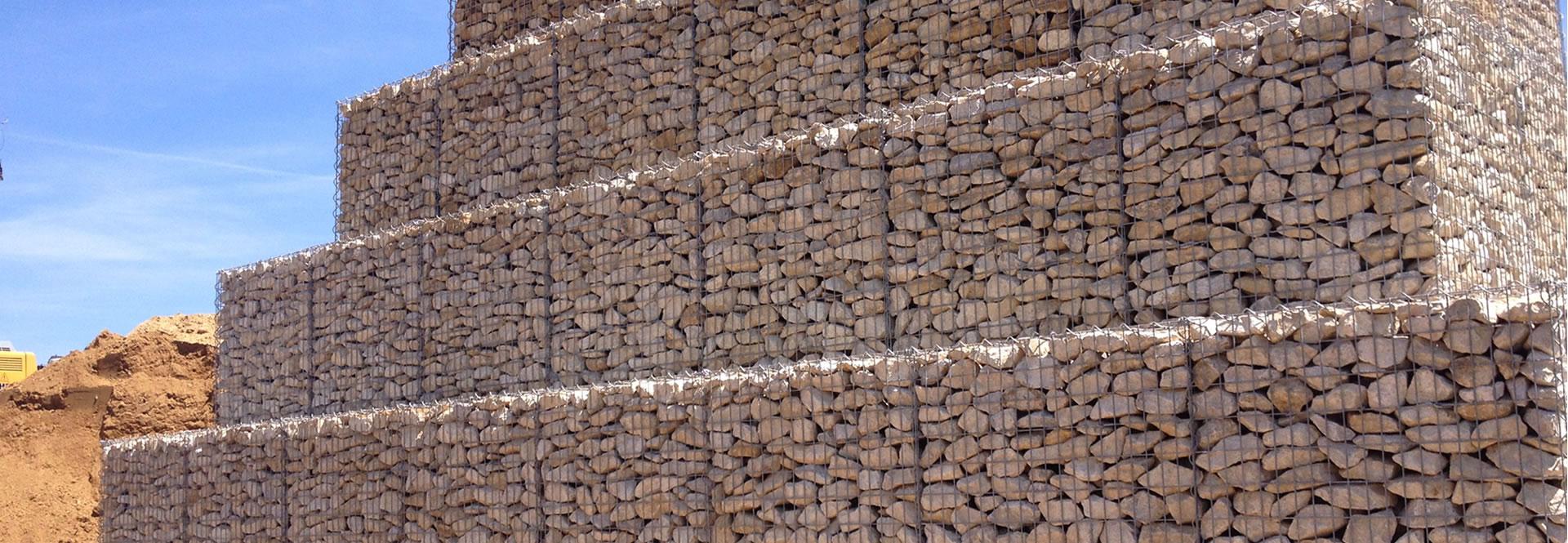 Several layers of welded gabions are piled up.