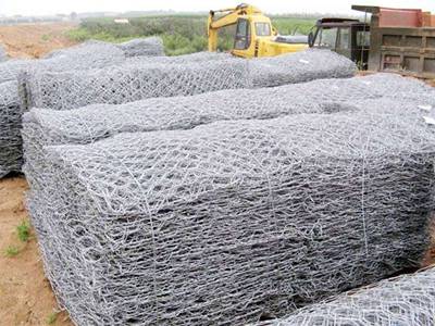 Several bundles of gabion boxes on the construction site.