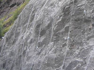 The hexagonal wire mesh is covering the mountains.