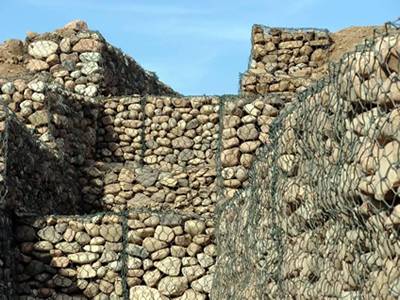 Several PVC coated gabion are piled up to form a retaining wall.